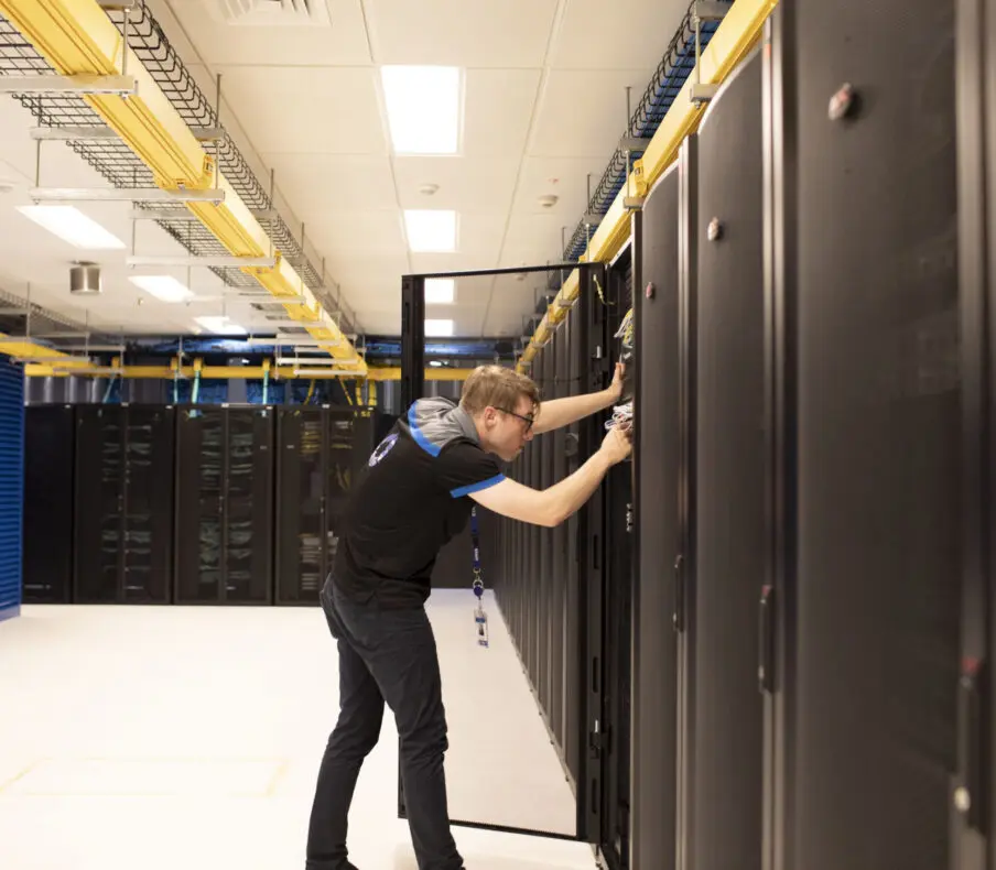 interactive technician looks at racks in data centre facility sydney
